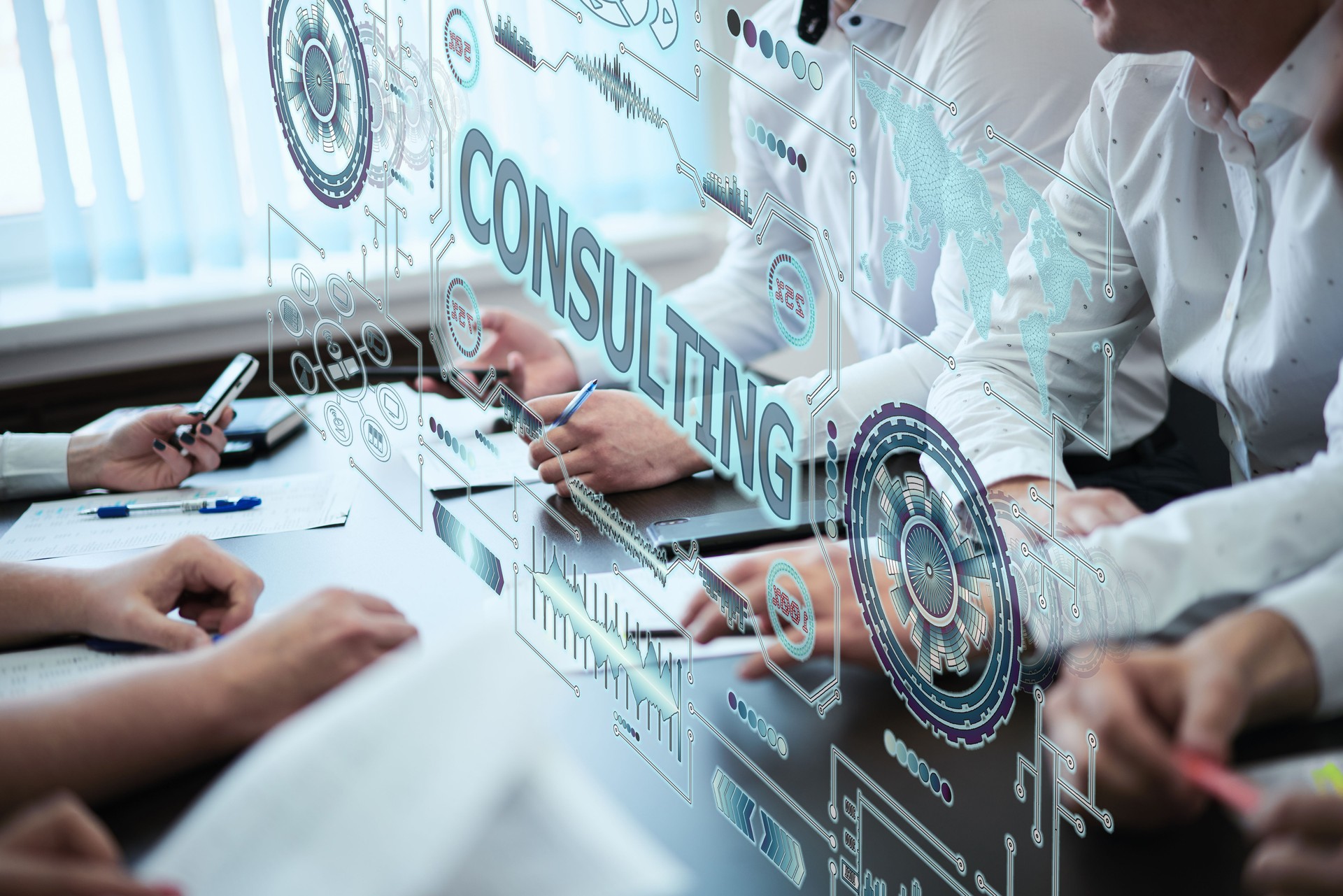 Business, technology, internet and network concept. A group of young people works with a hologram on the screen see the inscription: CONSULTING
